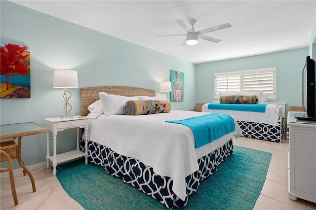 bedroom featuring a ceiling fan, baseboards, and tile patterned floors