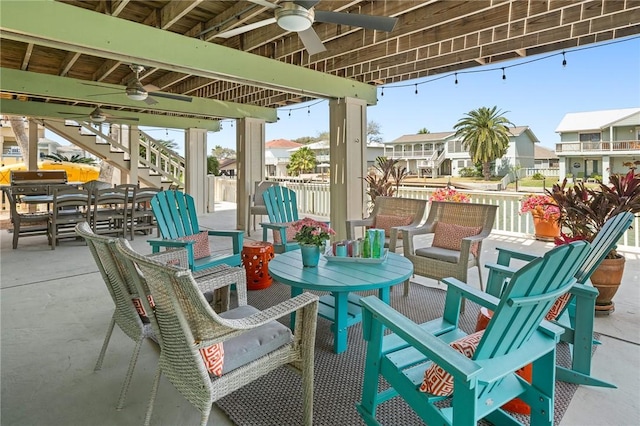 view of patio / terrace with a grill, a ceiling fan, stairway, a residential view, and outdoor dining space