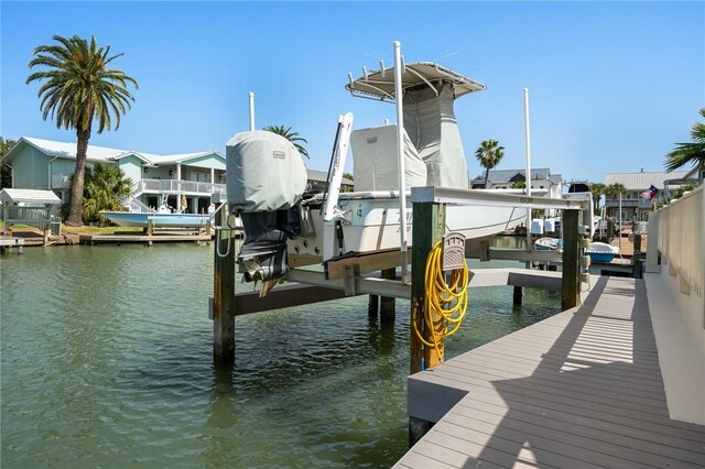 dock area with a water view and boat lift