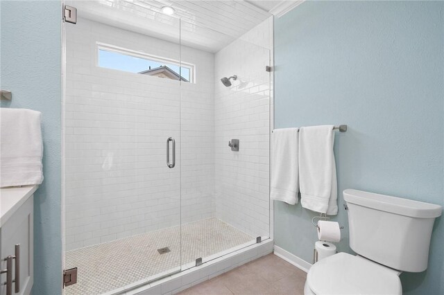 bathroom with toilet, ornamental molding, a shower stall, vanity, and tile patterned flooring