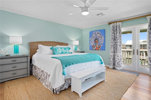 bedroom featuring visible vents, access to exterior, french doors, hardwood / wood-style floors, and crown molding