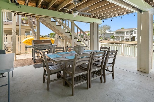 view of patio with stairs, outdoor dining area, and area for grilling