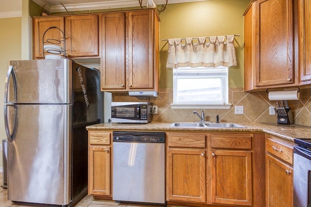 7009 Tocken Ct, Corpus Christi, TX 78414 - kitchen with appliances with stainless steel finishes, ornamental molding, decorative backsplash, and brown cabinets