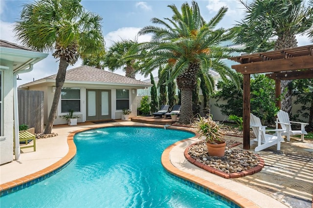 107 Angelfish, Aransas Pass, TX 78336 - outdoor pool featuring a pergola, french doors, a storage structure, a patio, and an outdoor structure