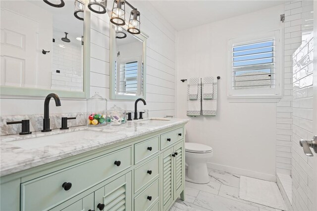 107 Angelfish, Aransas Pass, TX 78336 - bathroom featuring marble look tile flooring, healthy amount of natural light, double vanity, and tiled shower