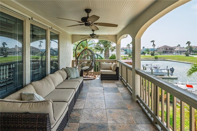 107 Angelfish, Aransas Pass, TX 78336 - view of patio featuring an outdoor living space, a ceiling fan, a water view, and a residential view