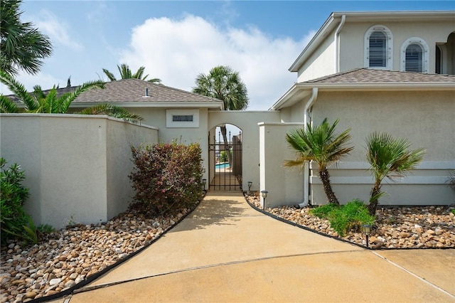 107 Angelfish, Aransas Pass, TX 78336 - entrance to property featuring stucco siding and a gate