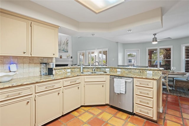 107 Angelfish, Aransas Pass, TX 78336 - kitchen featuring stainless steel dishwasher, cream cabinets, tasteful backsplash, a peninsula, and a ceiling fan
