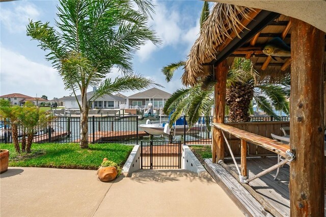 107 Angelfish, Aransas Pass, TX 78336 - view of patio / terrace with ceiling fan, a water view, and a residential view