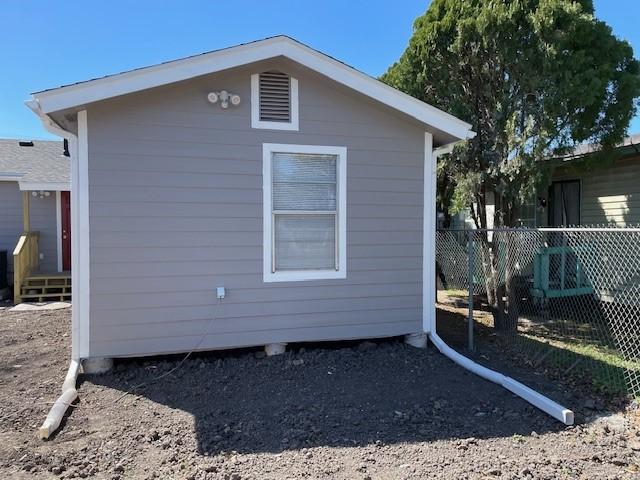 view of side of property featuring fence