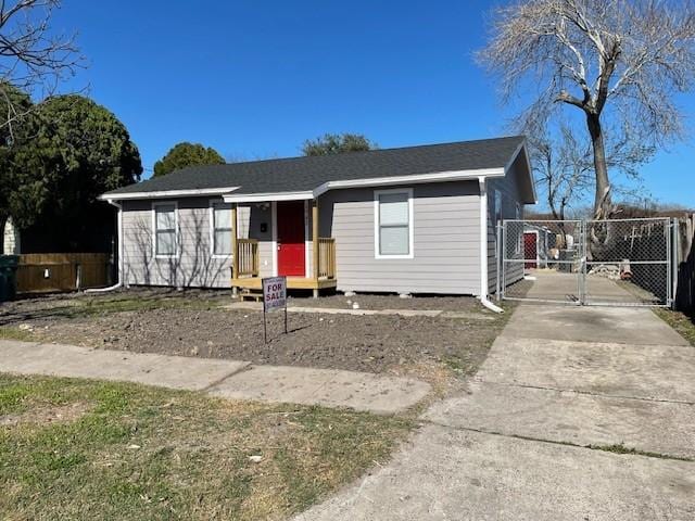 view of front of property featuring fence and a gate