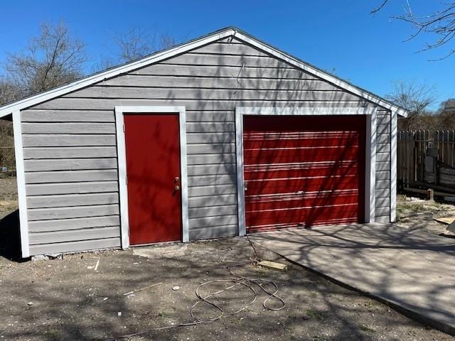 view of outbuilding featuring an outdoor structure and fence