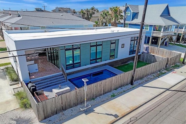 602 Island Retreat Ct, Port Aransas, TX 78373 - back of house with a fenced front yard and a residential view