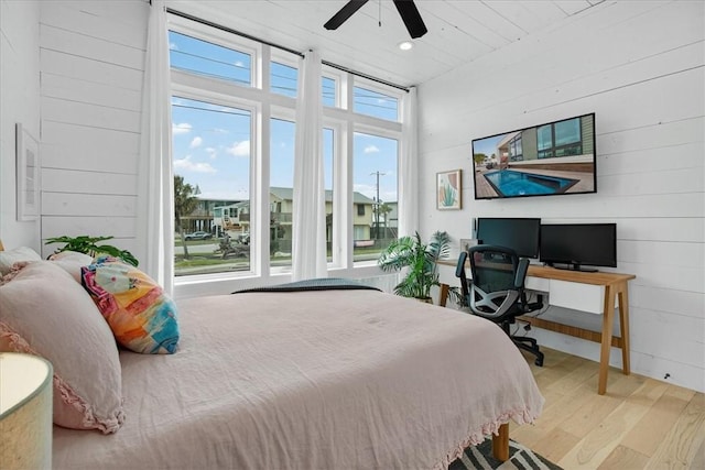 602 Island Retreat Ct, Port Aransas, TX 78373 - bedroom featuring wood finished floors, an office area, wooden walls, a ceiling fan, and recessed lighting