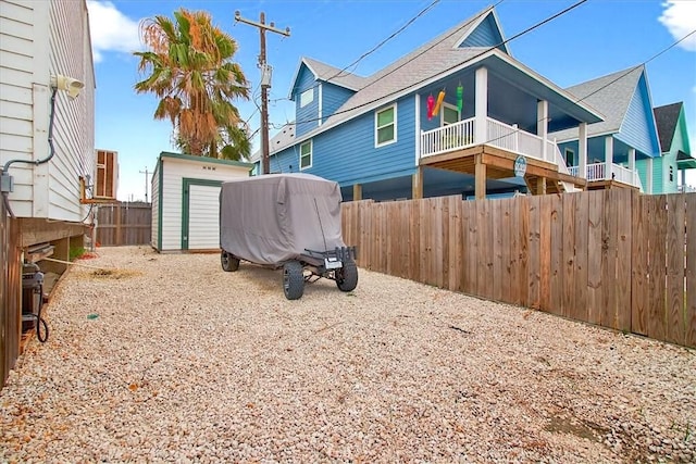 602 Island Retreat Ct, Port Aransas, TX 78373 - rear view of house with a storage unit and a fenced backyard
