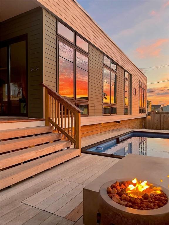 602 Island Retreat Ct, Port Aransas, TX 78373 - deck at dusk with an outdoor fire pit
