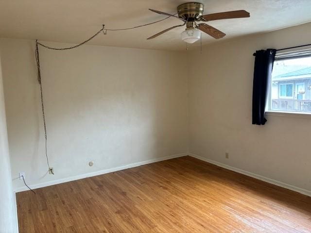 empty room with hardwood / wood-style flooring and ceiling fan