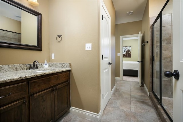 bathroom featuring vanity and a shower with shower door