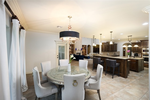 dining space featuring ornamental molding and light tile patterned floors