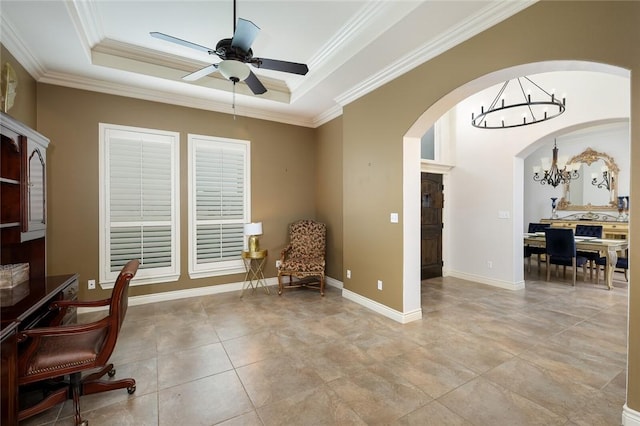 living area with a tray ceiling, ceiling fan with notable chandelier, and ornamental molding