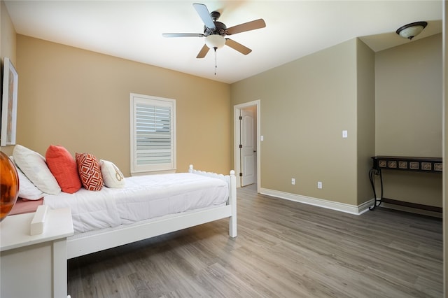 bedroom featuring hardwood / wood-style flooring and ceiling fan