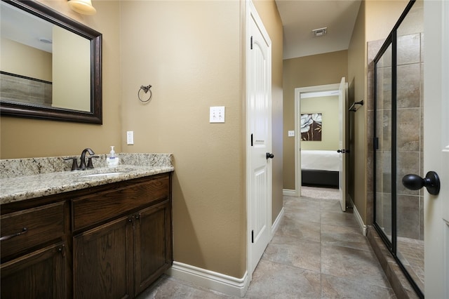 bathroom featuring vanity and an enclosed shower