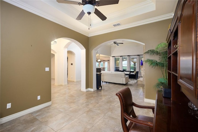 dining space featuring ornamental molding, a raised ceiling, ceiling fan, and light tile patterned flooring