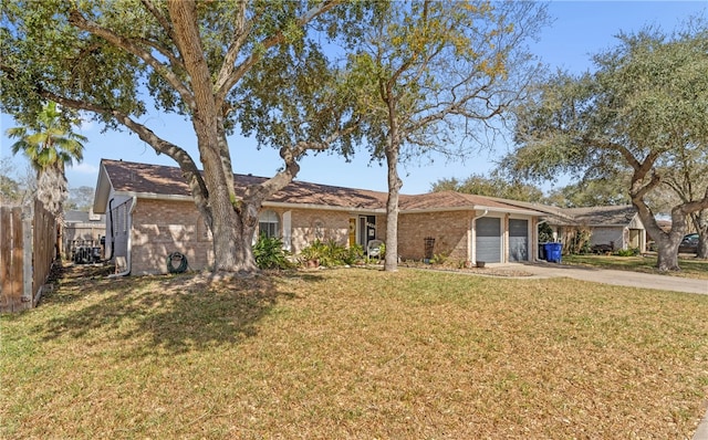 single story home with brick siding, fence, a garage, driveway, and a front lawn