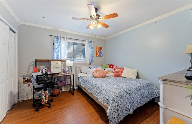 bedroom featuring a closet, crown molding, and wood finished floors