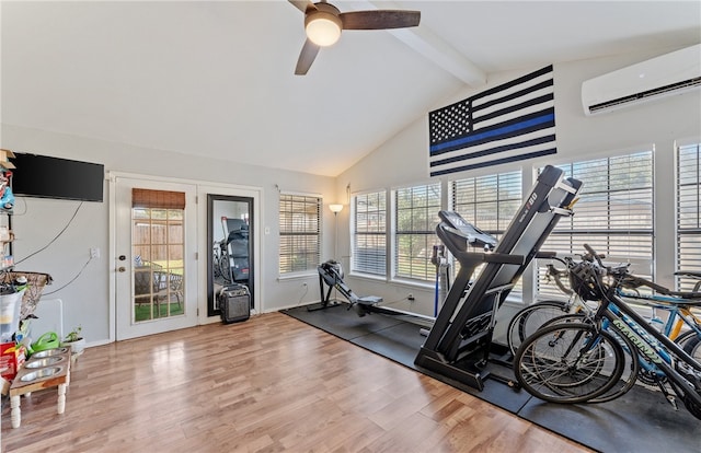 exercise room with high vaulted ceiling, a ceiling fan, wood finished floors, and a wall mounted AC