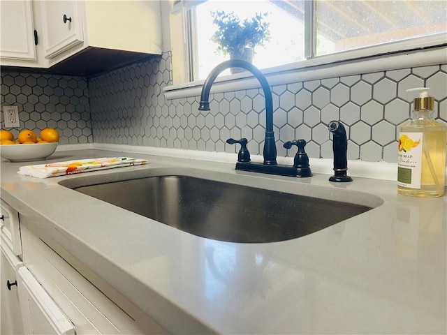4006 Hurlwood, Corpus Christi, TX 78410 - kitchen view of a sink, decorative backsplash, light countertops, and white cabinetry