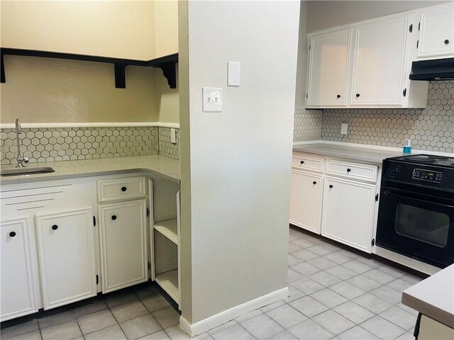 4006 Hurlwood, Corpus Christi, TX 78410 - kitchen with open shelves, range with electric cooktop, a sink, light countertops, and decorative backsplash