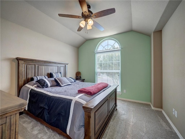 bedroom with baseboards, light carpet, ceiling fan, and lofted ceiling