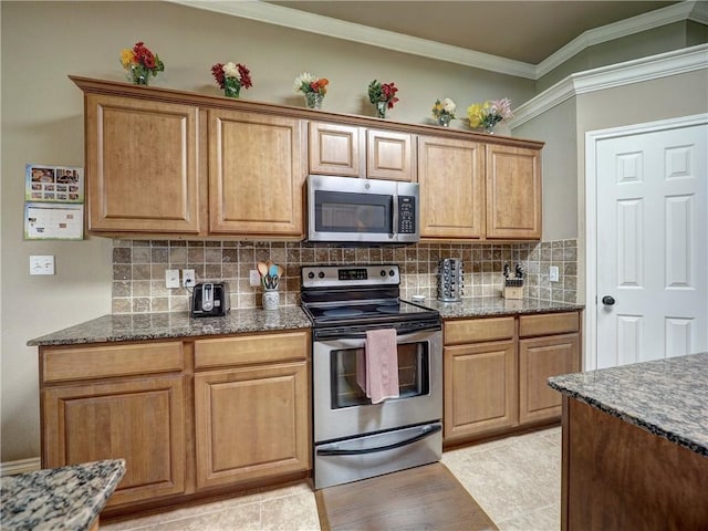kitchen with decorative backsplash, dark stone countertops, appliances with stainless steel finishes, and ornamental molding