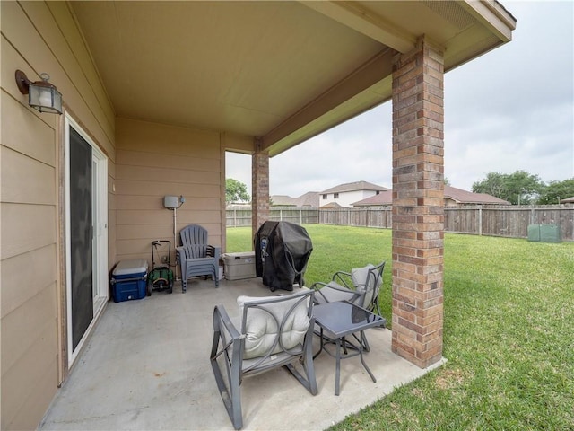 view of patio with grilling area and a fenced backyard