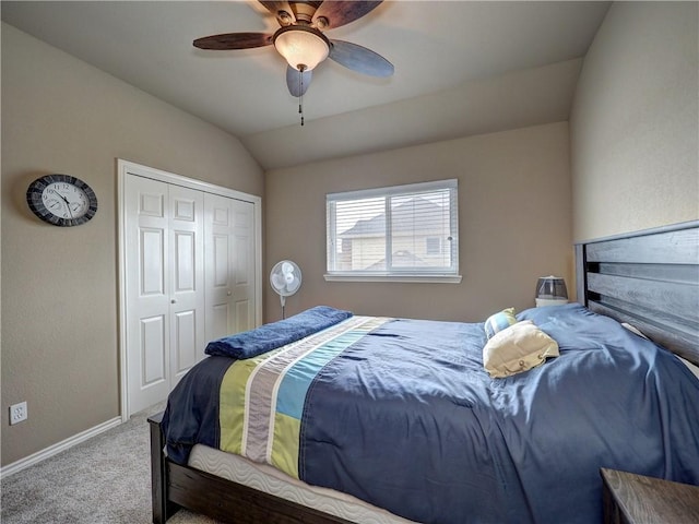 bedroom featuring ceiling fan, carpet floors, baseboards, vaulted ceiling, and a closet