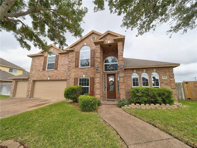 traditional home featuring driveway, a garage, brick siding, fence, and a front lawn