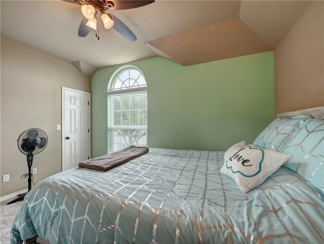 bedroom featuring baseboards, carpet, a ceiling fan, and lofted ceiling