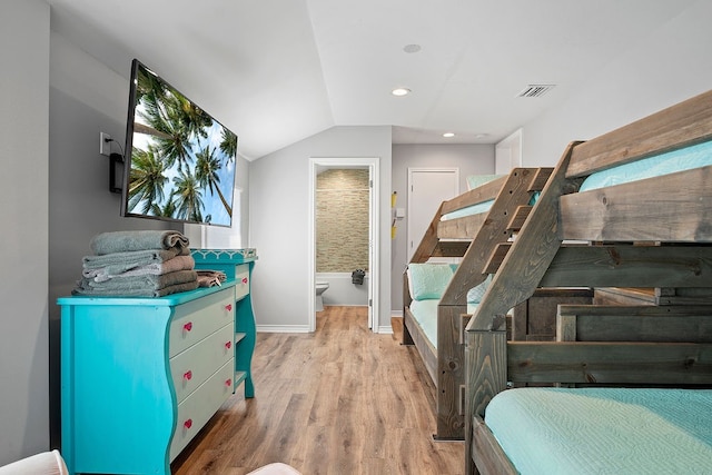 interior space with recessed lighting, wood finished floors, visible vents, baseboards, and vaulted ceiling