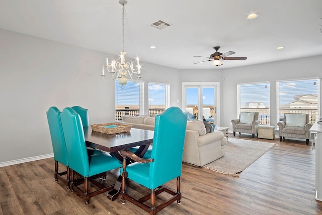 dining space featuring a wealth of natural light, wood finished floors, and visible vents