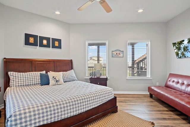 bedroom with a ceiling fan, baseboards, wood finished floors, and recessed lighting