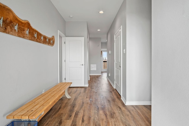 hall with recessed lighting, wood finished floors, and baseboards