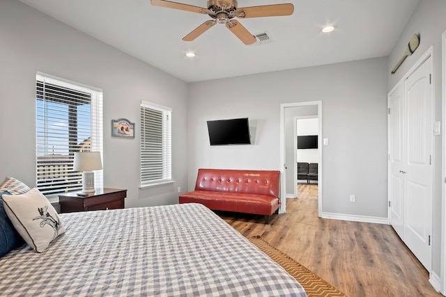 bedroom featuring recessed lighting, visible vents, ceiling fan, wood finished floors, and baseboards