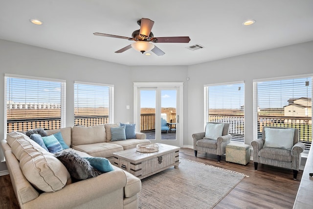 living area with recessed lighting, visible vents, ceiling fan, wood finished floors, and baseboards