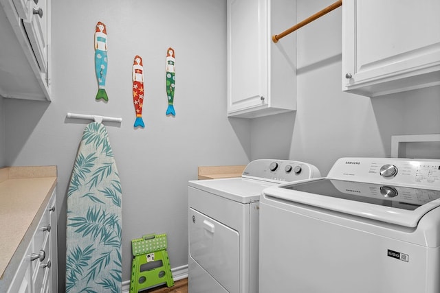 laundry room featuring independent washer and dryer and cabinet space