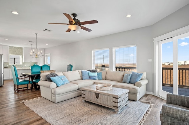 living room featuring recessed lighting, visible vents, a wealth of natural light, and wood finished floors