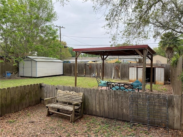 view of yard featuring a fenced backyard, a gazebo, an outbuilding, and a storage shed