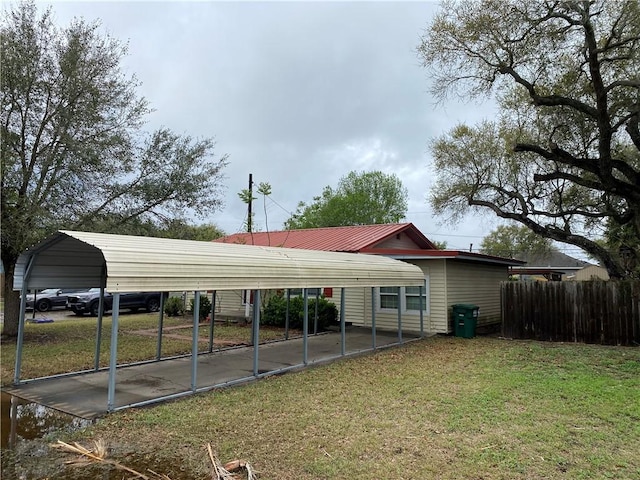 exterior space with a detached carport and fence