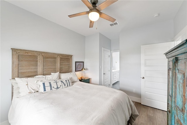 145 Beachwalk Prt, Aransas, TX 78373 - bedroom with wood finished floors, connected bathroom, and a ceiling fan