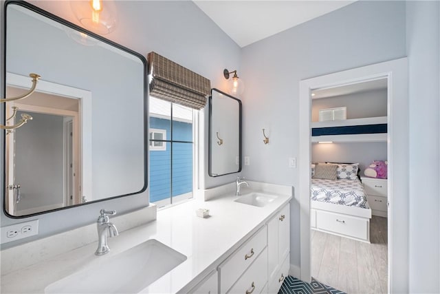 145 Beachwalk Prt, Aransas, TX 78373 - ensuite bathroom with double vanity and wood finished floors
